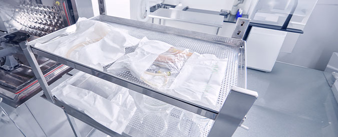 Verafit sterilization bags containing items ready to be sterilized on a rolling cart